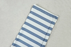 Detail of blue and white striped fabric showing fine stitching on the jumpsuit cuff