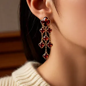 18k gold plated vintage clover tassel earrings with deep red gemstones on model
