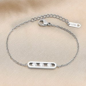 Detail of stainless steel bracelet featuring three sliding zircons on champagne silk