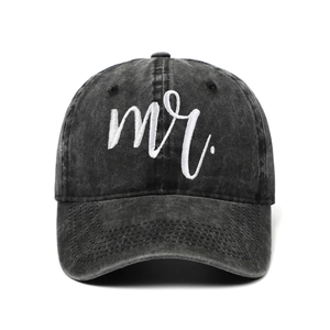 Close-up of white mr. embroidery on a vintage washed black cotton baseball cap detail