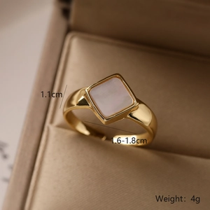 Macro shot of gold-plated heart ring with square mother of pearl inlay and size details