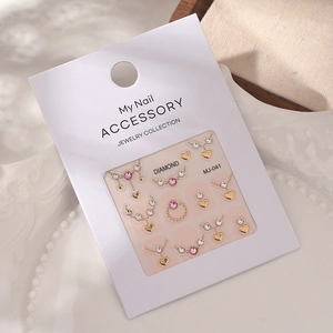 Nail art decoration kit MJ-041 with pink crystals and heart charms in white packaging