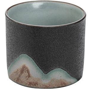 Japanese ceramic tea cup with mountain pattern and smooth light blue interior glaze