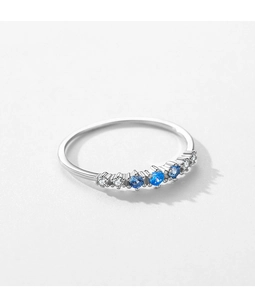 Macro detail of S925 silver ring featuring blue and white zircon stones in row setting