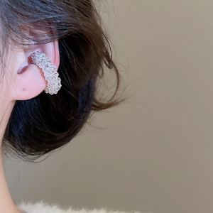Close-up of elegant flower beaded ear cuff made with transparent faceted silver beads