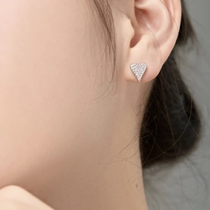 Close-up of S925 silver heart stud earrings with sparkling micro-paved cubic zirconia stones