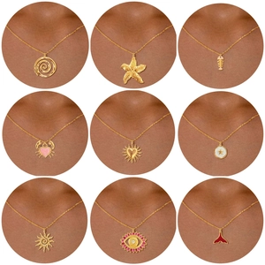 Collection of golden stainless steel necklaces featuring starfish, crab and fish tail pendants