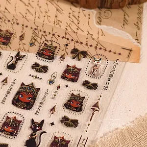 Macro shot of ancient Egyptian cat nail stickers with gold accents on vintage paper