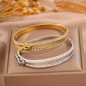 Unique zipper-style stainless steel bangles with sparkling crystals in gold and silver