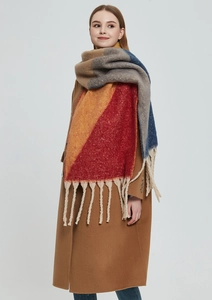 Close-up of thick multi-color chunky knit scarf with long tassels and soft texture