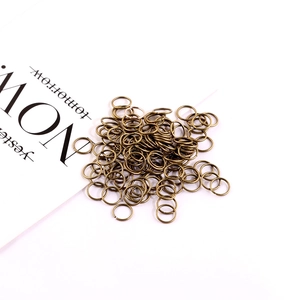 Detail view of antique bronze jump rings for DIY jewelry making on white background