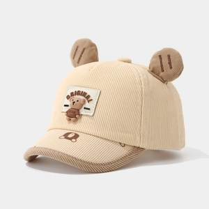 Detail of beige corduroy kids baseball cap with 3D bear ears and embroidered logo