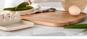 Beige silicone kitchen utensil rest with multiple slots on a kitchen counter