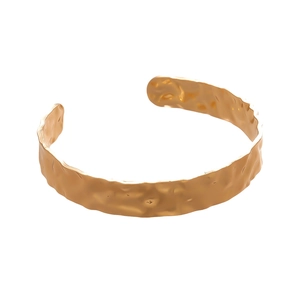 Gold hammered cuff bracelet with textured geometric wrinkles and an open adjustable design