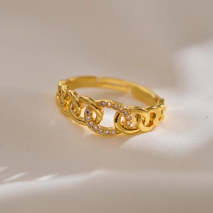 Macro shot of gold chain link ring with micro zircon inlay and adjustable open band