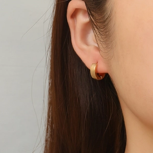 Golden brushed stainless steel hoop earrings for a minimalist and stylish aesthetic