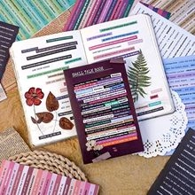Retro scrapbook stickers and small talk book laid on lace and linen for DIY crafts