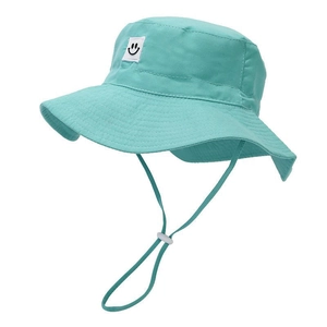 Detail view of mint green sun hat with smiley face patch and adjustable windproof strap