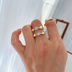 Gold-plated ring set with micro-pave zircons and pyramid studs worn by a model