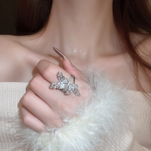 Detailed view of a silver double butterfly ring with micro-pave crystals on hand