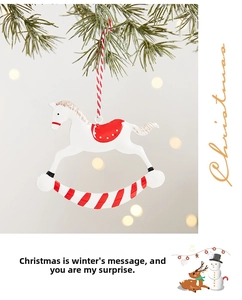 Detailed view of rocking horse Christmas ornament hanging on a festive pine branch