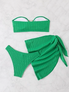 Three-piece green bikini set with bandeau top and matching textured beach sarong