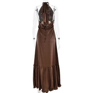 Detail of brown polka dot halter dress featuring an open back and elegant waist tie