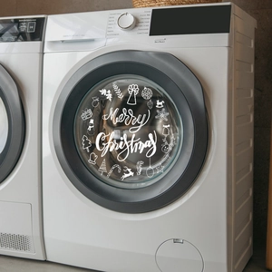 White Merry Christmas decal with reindeer and snowflakes on a washing machine glass door