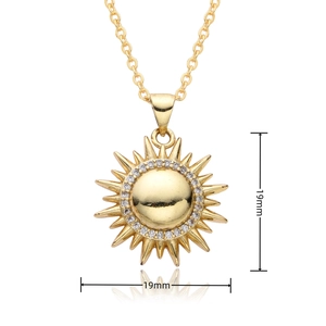 Detail view of a 19mm gold sun pendant necklace with sparkling white cubic zirconia stones