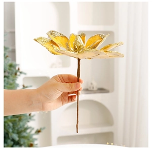 Close-up of a gold glittered artificial magnolia flower for Christmas tree decoration