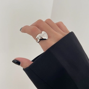 Close-up of S925 silver heart ring with LOVE ME engraving worn on index finger