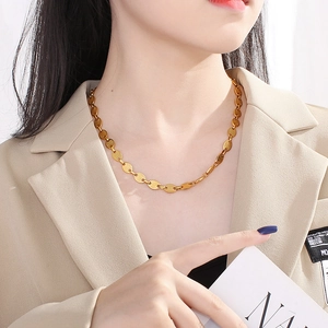 Elegant 18k gold plated titanium coffee bean pig nose link necklace worn by model