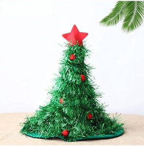 Detail of green tinsel Christmas tree hat with red pom poms and a red star on top