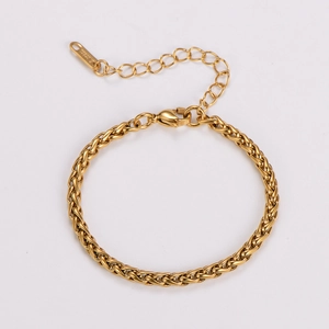 Detail view of woven stainless steel chain bracelet in gold finish with lobster clasp