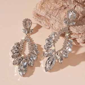 Macro view of crystal teardrop earrings with silver finish and sparkling floral pattern