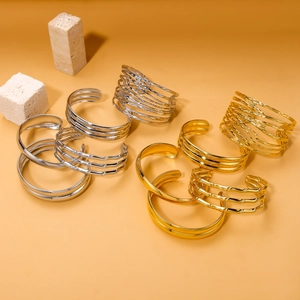 Stackable gold and silver stainless steel open bangles in minimalist and textured designs