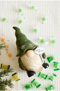 Close-up of ceramic Christmas gnome jar with Merry Christmas sign and candy accents