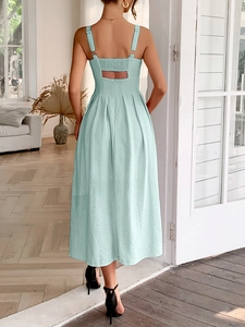 Detail of mint green sleeveless dress with back cutout and elegant pleated texture