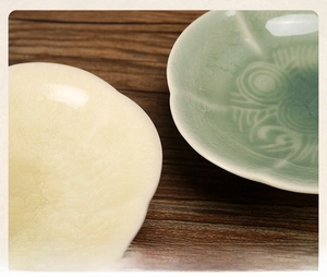 Macro view of crackle glaze ceramic tea plates with elegant six-petal flower edges