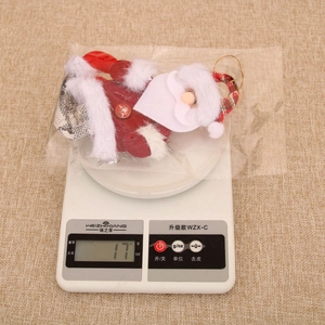 Detailed close-up showing a 17g lightweight Santa Claus plush ornament with gold hanging cord