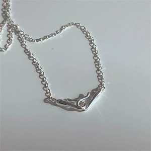 Macro shot of 925 sterling silver hook clasp detail on a minimalist silver necklace