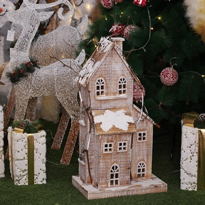 Lighted wooden Christmas house decoration with snowy roof and vintage rustic finish