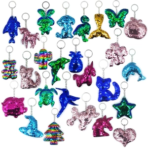 Flat lay of colorful sequin keychains in shapes like unicorns, stars, and hearts