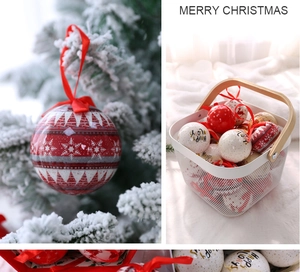 Detail of red and white Christmas balls with Merry Christmas prints on snow-covered tree