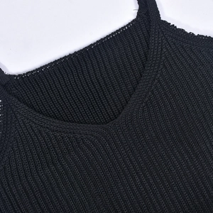 Detailed view of V-neck stitching and knitted texture on a black fringe camisole top