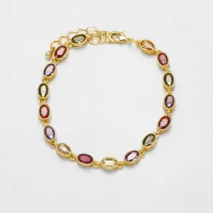Macro view of multi-colored oval gemstones and 18k gold-plated chain with lobster clasp