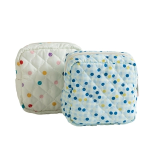 Quilted floral sanitary pad pouch with polka dot patterns for travel and storage