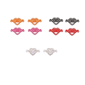 Macro shot of colorful heart-shaped winged jewelry clasps with rhinestones and keyhole detail
