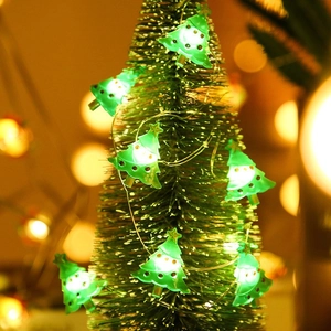 Detailed view of LED Christmas tree string lights with a warm festive glow on a green frame