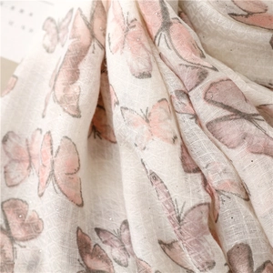 Close-up of pink butterfly printed scarf with cotton linen texture and sparkling glitter